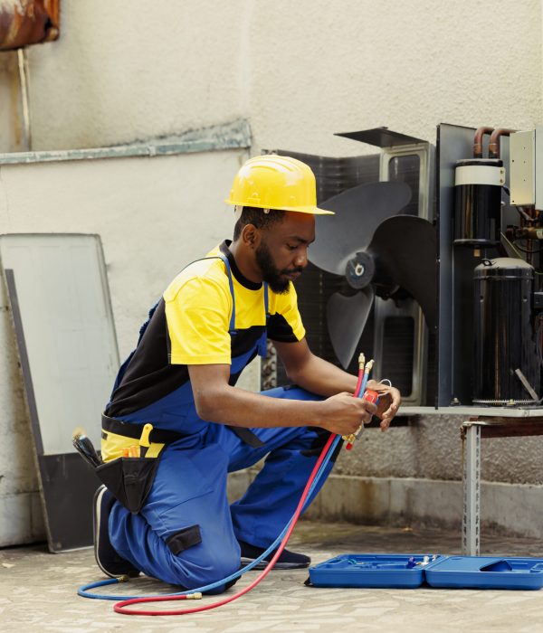Knowleadgeable engineer doing annual hvac system maintenance, assembling manometers before starting work. Certified technician getting pressure checking tool ready for air conditioner freon tank